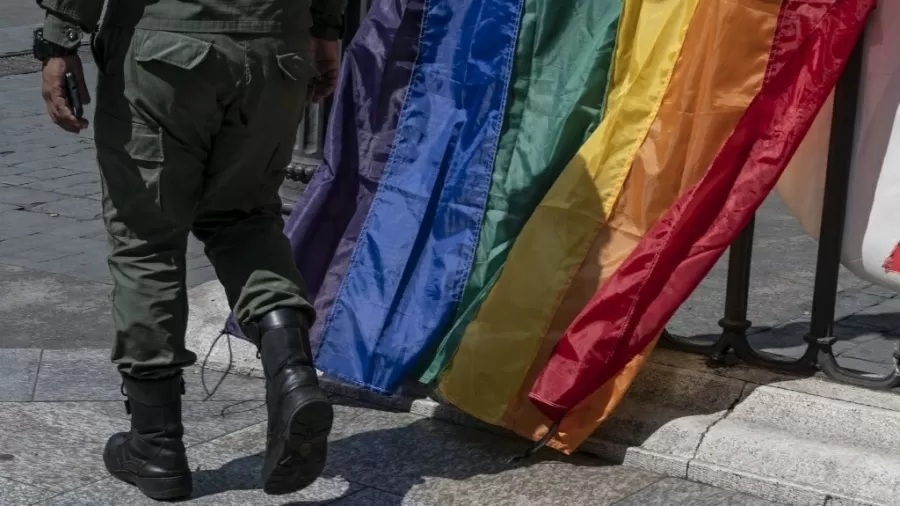 membro-da-guarda-nacional-bolivariana-caminha-em-frente-a-bandeiras-do-arco-iris-de-manifestacao-da-comunidade-lgbt-em-caracas-na-venezuela-1650463882874_v2_900x506.jpg